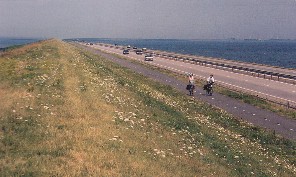 On our right the open sea on our left the lake, all water. Before us a straight line: The Dam